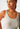 Close-up view of a women model wearing SK dune flowers cotton Tank top