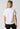 Back view of a women model wearing SK white cotton Shirt short sleeve