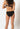 Back view of a women model wearing SK black cotton Bikini briefs 2 pack